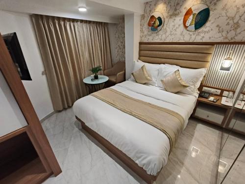 a bedroom with a large bed in a room at Hotel Prime Suites Airoli in Navi Mumbai