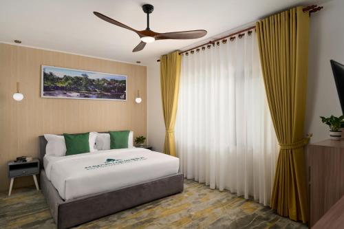a bedroom with a bed and a ceiling fan at Smile Boutique Hotel By EHM in Phnom Penh
