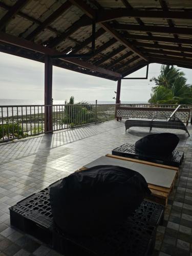 two black pillows on a patio with the ocean in the background at Marick Beach Resort in Carmen