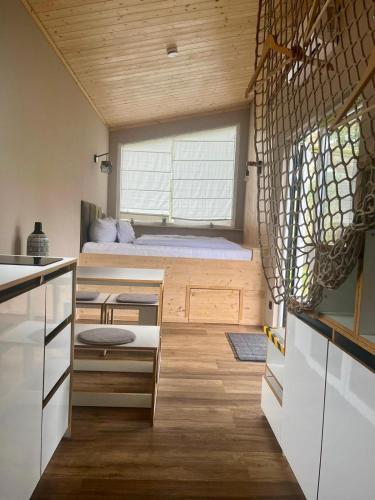 a small room with a bed and a window at Lieblingsplatz Strandhotel in Sankt Peter-Ording