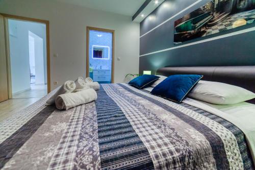 a bedroom with a large bed with blue walls at Bella Casa in Sukošan