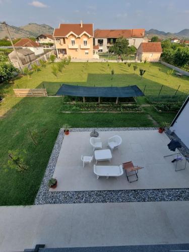 an aerial view of a backyard with a table and chairs at Bright & Cozy Apartment in quiet area near Airport in Golubovci