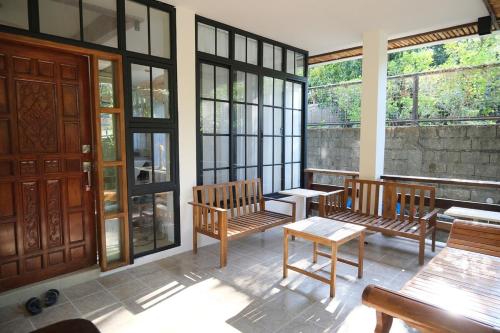 a room with benches and tables and windows at Casa Frania in San Fernando