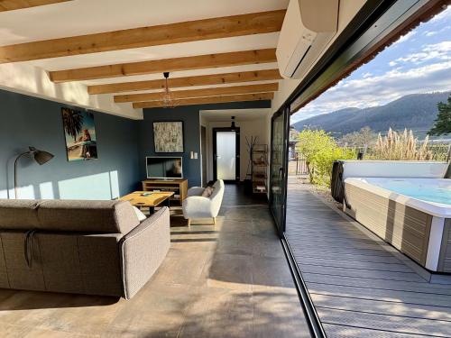 - un salon avec une baignoire, un canapé et une table dans l'établissement Sweet Escape et Spa, à Turckheim