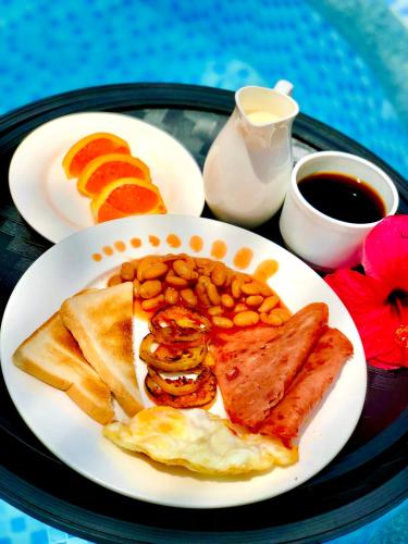 a plate of breakfast food with eggs beans and toast at Marick Beach Resort in Carmen