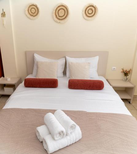a bedroom with a white bed with towels on it at Stergios_Apartments 02 in Kozani