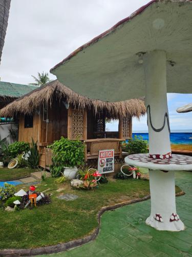 a house on the beach with a surfboard in front of it at Marick Beach Resort in Carmen