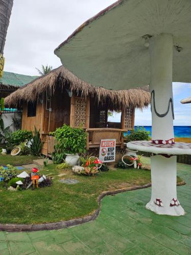 a hut with a surfboard in front of it at Marick Beach Resort in Carmen