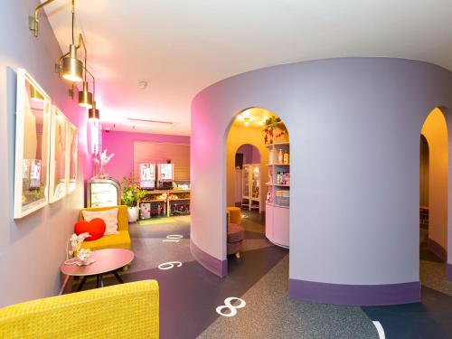 a colorful living room with a couch and a table at デザイナーズホテル アリス -Adult only- in Sasebo