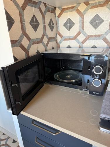 a microwave oven sitting on top of a kitchen counter at Elisir house in Palermo
