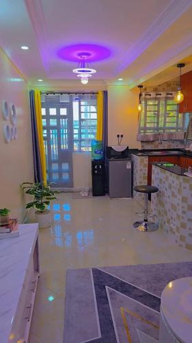 a living room with a purple ceiling and a bar at KenPam BNB in Isiolo