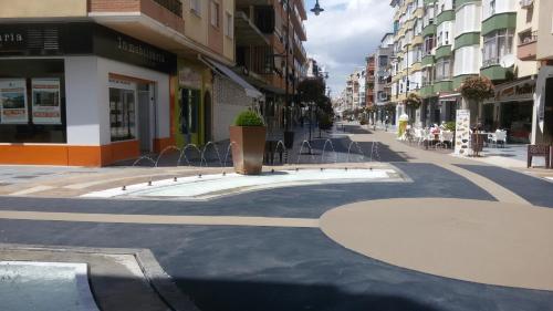 an empty street in a city with buildings at Apartamentos Poniente - Mares in Torre del Mar