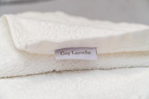 a stack of white towels with a tag on it at Stergios_Apartments 02 in Kozani