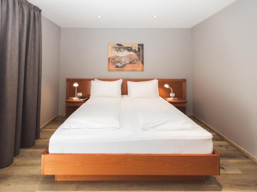 a bedroom with a large bed with two night stands at Hotel Panorama in Rablà
