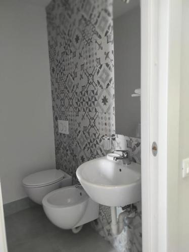 a bathroom with a sink and a toilet at Villino Saraceno Rostain in Borgio Verezzi
