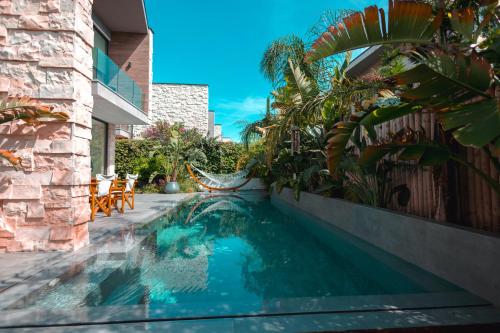 a swimming pool in front of a house at Escape by Form Villa Olea in Dhërmi