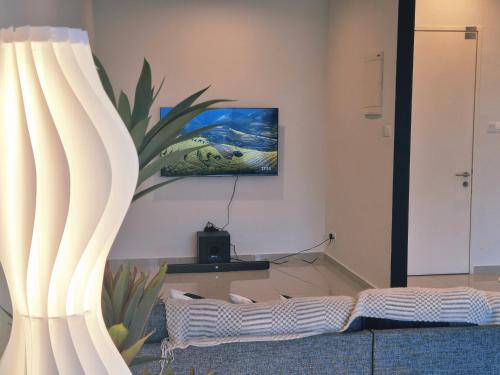 a living room with a tv on the wall at SKS Pavilion Ultimate Skyline w Bathtub 3 BR, 6 Pax in Johor Bahru