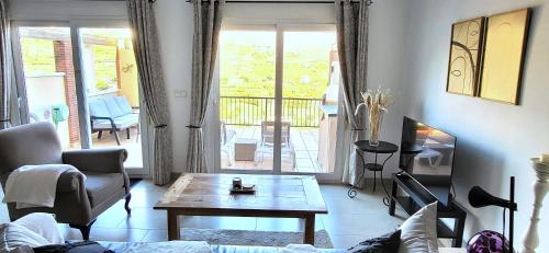 a living room with a couch and a table at Casa Londi in Almuñécar