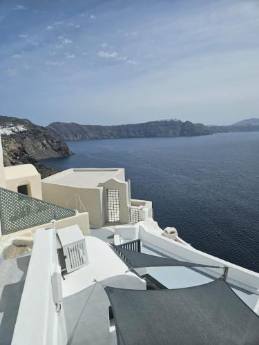 a view of the ocean from a balcony of a house at Phaos Oia Suites in Oia