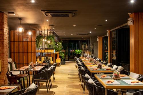 a dining room with long tables and chairs at Diamond Resort Phuket Official Account in Bang Tao Beach