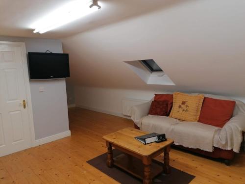 a living room with a couch and a table at Bayview Lodge in Monargan Glebe