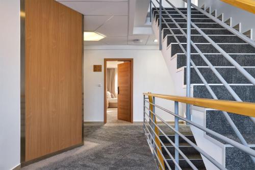 a staircase in an office building with a stair case at Hotel Osvit in Mladá Boleslav