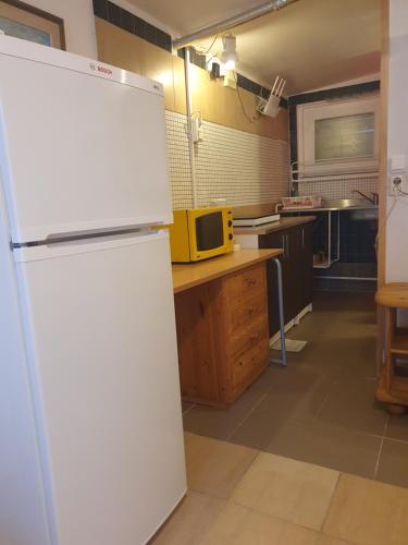 a kitchen with a white refrigerator in a kitchen at Motel E4 Kolmården Apartments And Cottages in Kolmården