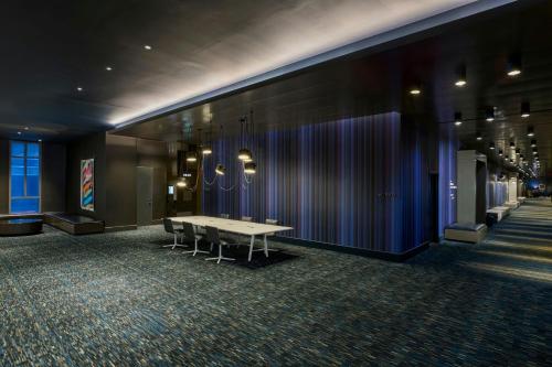 a conference room with a table and chairs against a wall at W Philadelphia in Philadelphia