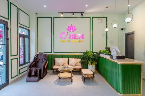 a waiting room with a couch and chairs and a table at Osen Hotel - Grand World Phu Quoc in Phu Quoc