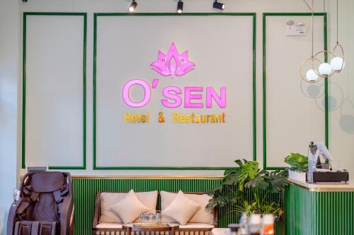 a large sign in a room with a couch and a sign at Osen Hotel - Grand World Phu Quoc in Phu Quoc