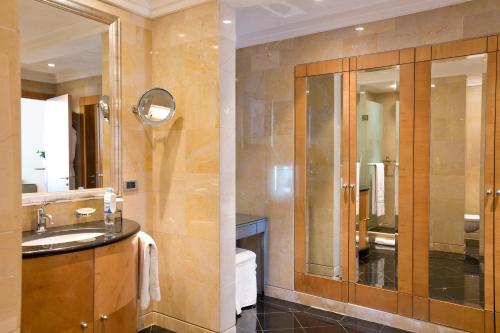 a bathroom with a sink and a large mirror at Phoenicia Residence in Beirut