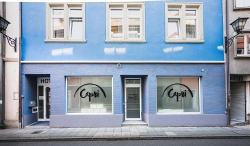 a blue building with the words covenant on the windows at Hotel Capri in Überlingen
