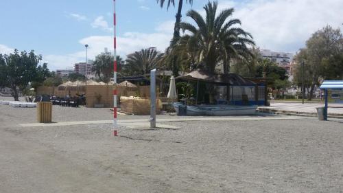 a street with a building and a bus stop at Las Américas - Mares in Torre del Mar
