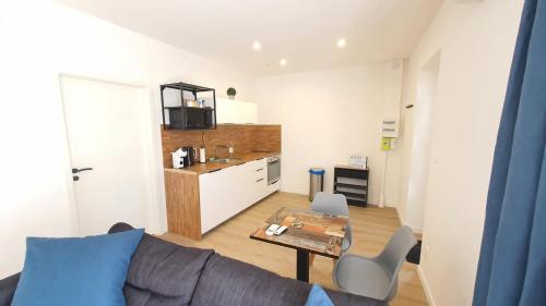 a living room with a couch and a table at Cozy and chic apartment 2 in Freyming