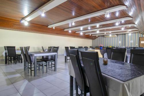 a dining room with black tables and chairs at OYO New Anápolis Hotel, Imperatriz in Imperatriz
