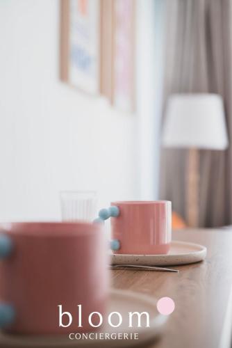 a cup of coffee sitting on a wooden table at Le magnifique Lafayette appartement tout équipé in Nancy