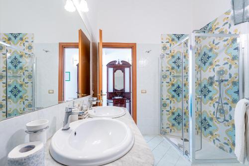 a bathroom with two sinks and a shower at Hotel Fontana in Amalfi