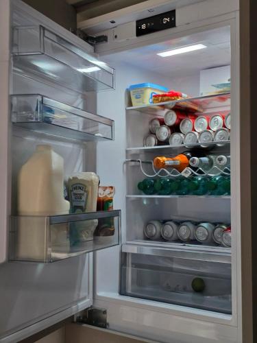 an open refrigerator filled with lots of food and drinks at Perfect home from home, Heart of Belfast Sleeps 6 in Belfast