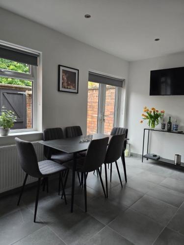 a dining room with a table and chairs at Perfect home from home, Heart of Belfast Sleeps 6 in Belfast