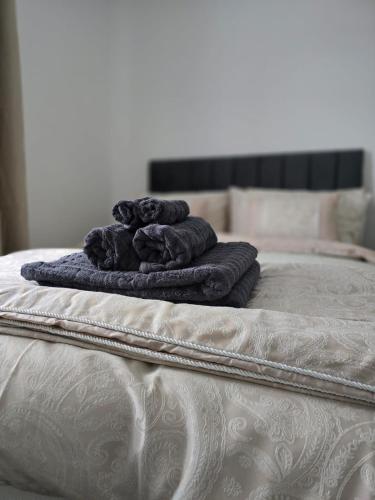 a pile of towels sitting on top of a bed at Perfect home from home, Heart of Belfast Sleeps 6 in Belfast