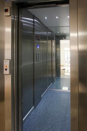 an elevator in an office building with a hallway at Finestre d'Occidente in Trapani