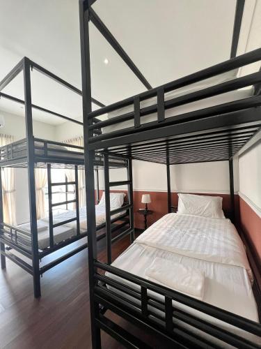 a bedroom with two bunk beds in it at Senai Hill 24 Homestay in Kampong Saleng
