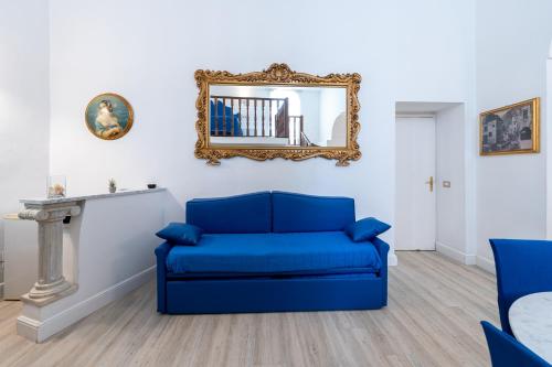 a blue couch in a living room with a mirror at Hotel Fontana in Amalfi