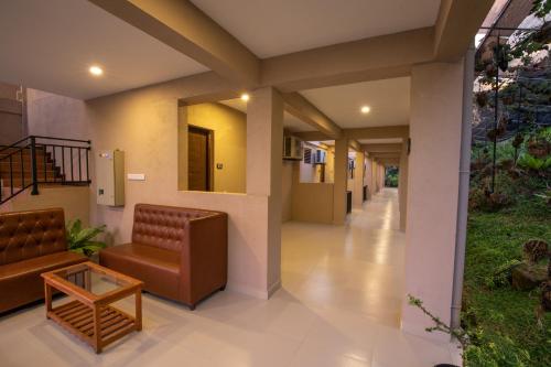 a hallway of a hospital with a couch and a table at Akway Resort Beragala Haputale in Beragala