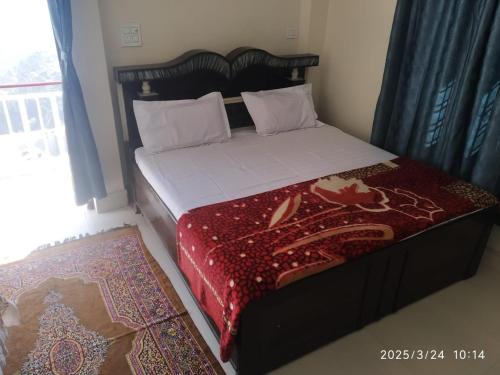 Ένα ή περισσότερα κρεβάτια σε δωμάτιο στο Shree Balaji Homestay