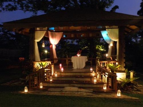 a gazebo with a table and lights on it at White Guest House -Kakiri in Kampala