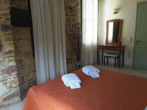 a bedroom with a bed with two towels on it at Frourio Apartments in Chios