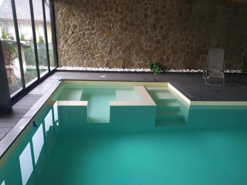 a large swimming pool in a room with a window at Chata na hradzi in Lekárt