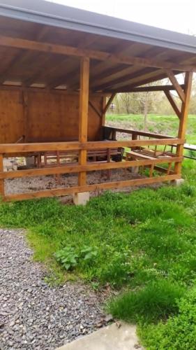 a wooden picnic table in a field with green grass at Chata na hradzi in Lekárt
