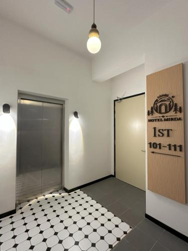 a room with two doors and a tiled floor at Hotel Mirda Puncak Alam in Bandar Puncak Alam
